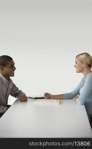 Happy businesspeople in a meeting at desk