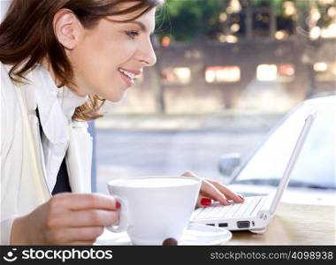 happy businesswoman drinking morning coffee and surfing internet