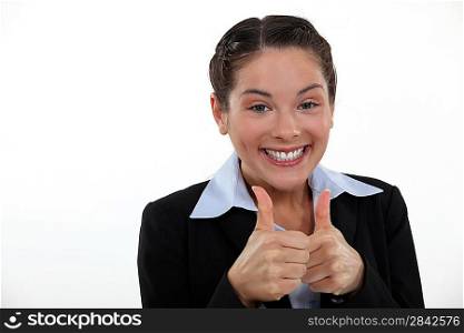 Happy businesswoman giving thumbs-up gesture