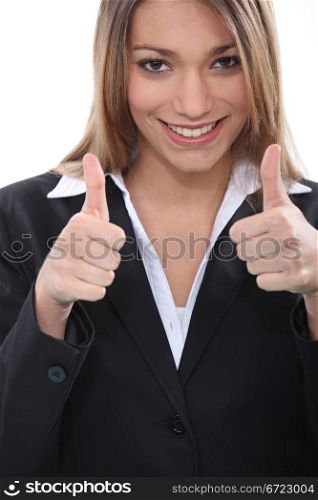 Happy businesswoman giving thumbs up gesture