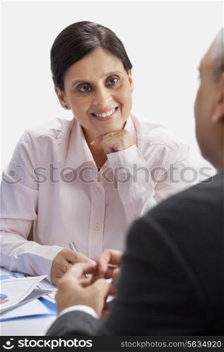 Happy businesswoman listening to male executive