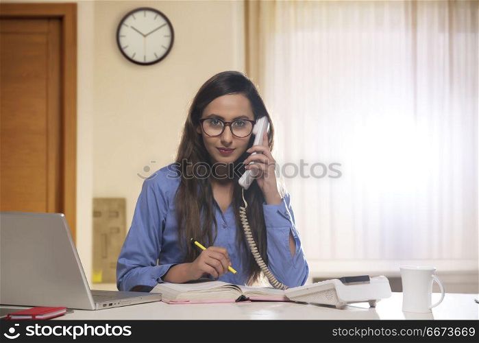 Happy businesswoman on the phone in the office
