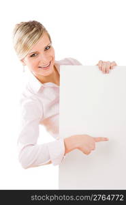 Happy businesswoman pointing aside at blank advertising banner on white