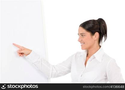 Happy businesswoman pointing at empty flip chart on white