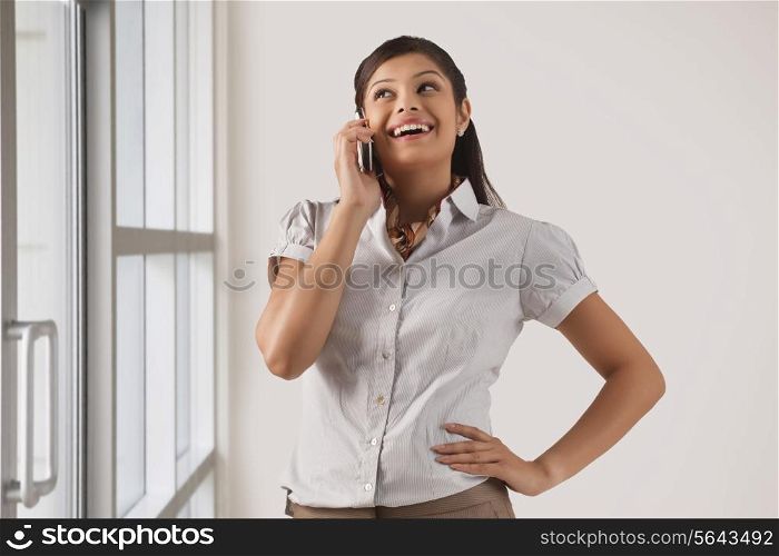 Happy businesswoman speaking on mobile phone