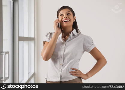 Happy businesswoman speaking on mobile phone