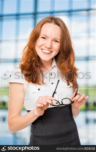Happy businesswoman with glasses in the office