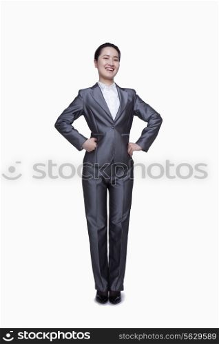 Happy businesswoman with hands on her hips