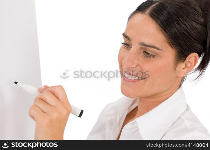 Happy businesswoman writing at empty flip chart on white