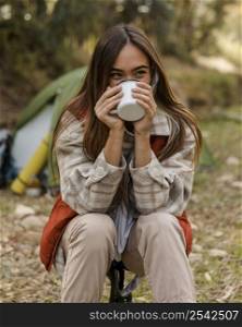 happy camping girl forest drinking from mug