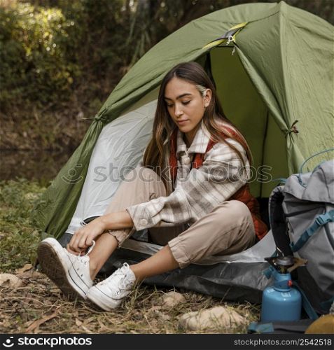 happy camping girl forest tying her laces