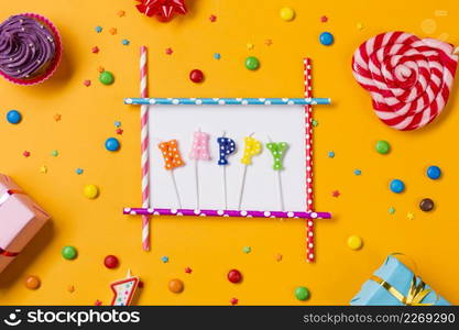 happy candle with muffins gems sprinkles gift boxes heart shape lollipop orange backdrop