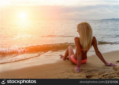 Happy Carefree Woman Enjoying Beautiful Sunset on the Beach. Happy Carefree Woman on the Beach