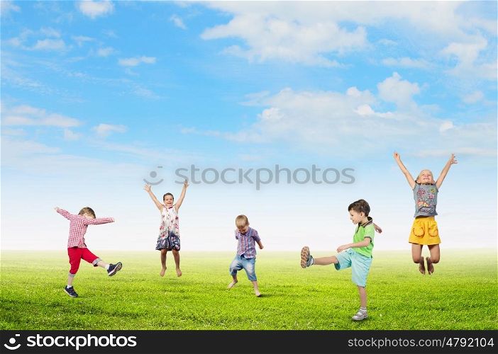 Happy careless childhood. Group of children jumping high in sky joyfully