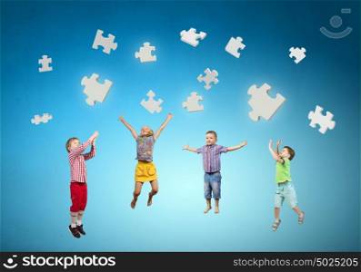 Happy careless childhood. Group of children jumping high joyfully on colorful background