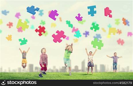 Happy careless childhood. Group of children jumping high joyfully on natural background