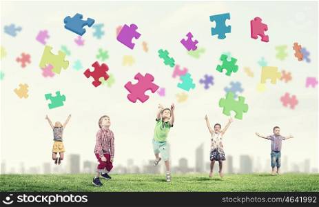 Happy careless childhood. Group of children jumping high joyfully on natural background