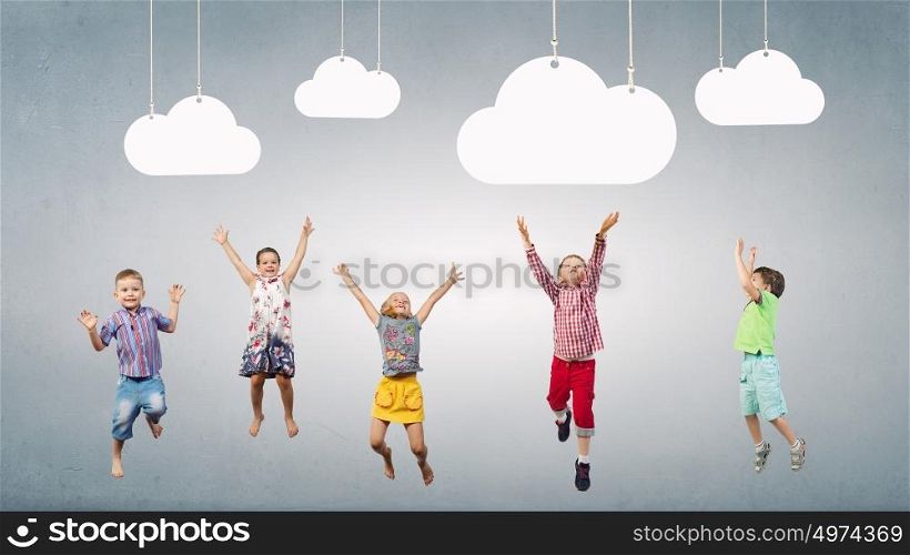 Happy careless childhood. Group of happy children playing on concrete background