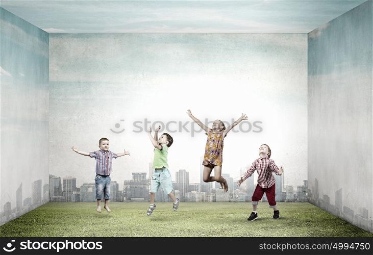 Happy careless childhood. Group of happy children playing on concrete background