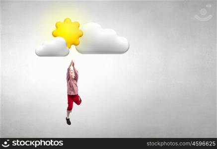 Happy careless childhood. Little happy cute boy catching sun in sky