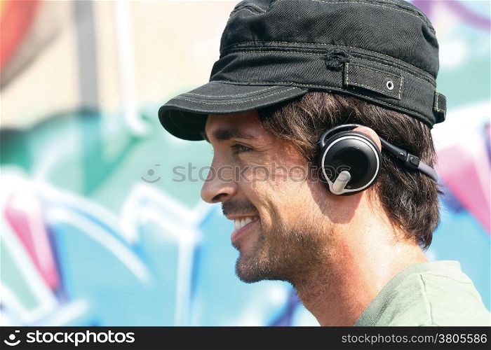 happy casual guy listening to player in earphones