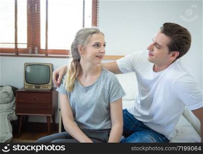 Happy caucasian couple talk and have leisure time together at home.