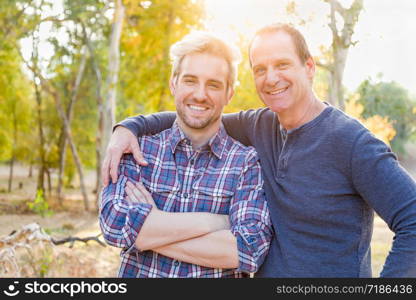 Happy Caucasian Father and Son Portrait Outdoors.