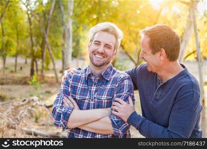 Happy Caucasian Father and Son Portrait Outdoors.