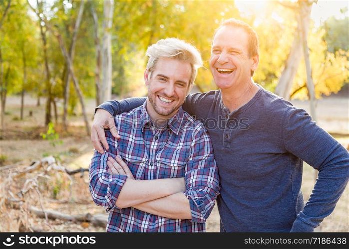 Happy Caucasian Father and Son Portrait Outdoors.