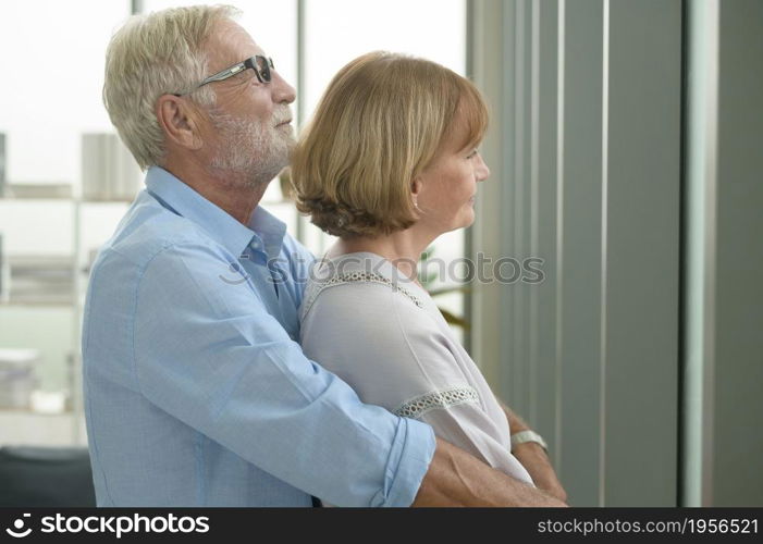 Happy Caucasian senior couple relaxing in living room at home