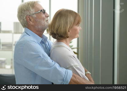 Happy Caucasian senior couple relaxing in living room at home