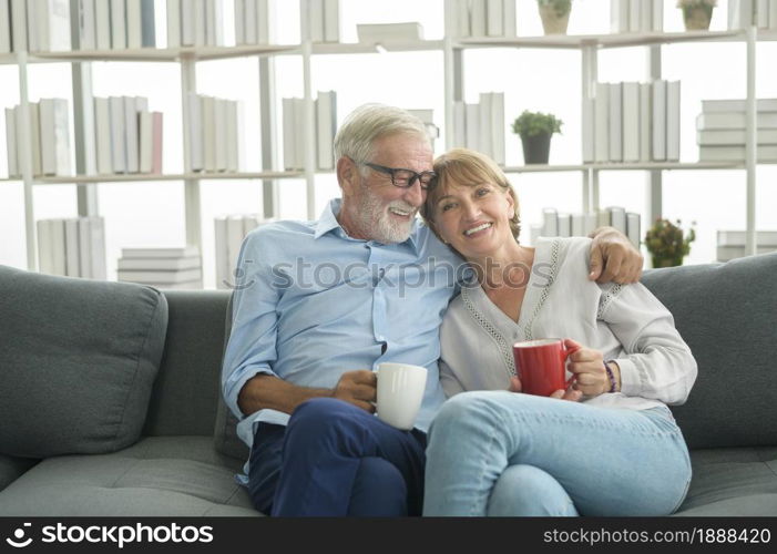 Happy Caucasian seniors couple are drinking coffee in home , relaxing and health care concept .