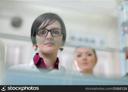 Happy cheerful pharmacist chemist woman standing in pharmacy drugstore
