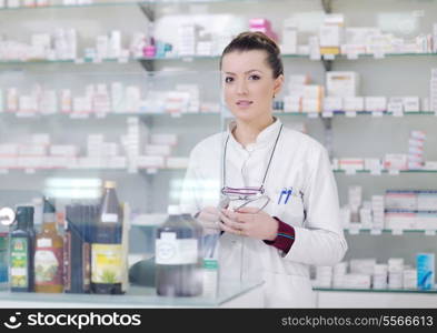 Happy cheerful pharmacist chemist woman standing in pharmacy drugstore