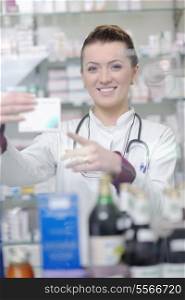 Happy cheerful pharmacist chemist woman standing in pharmacy drugstore