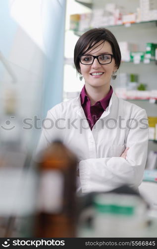 Happy cheerful pharmacist chemist woman standing in pharmacy drugstore