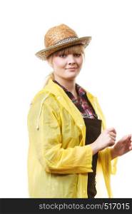 Happy cheerful smiling woman gardener in sun hat and yellow raincoat waiting for rain. Happy smiling gardener in sun hat and raincoat