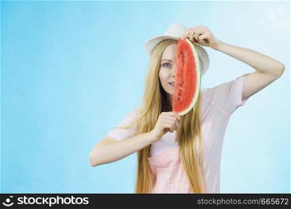 Happy cheerful teenage girl ready for summer wearing sun hat holding sweet fruit red juicy watermelon, on blue. woman holding watermelon fruit