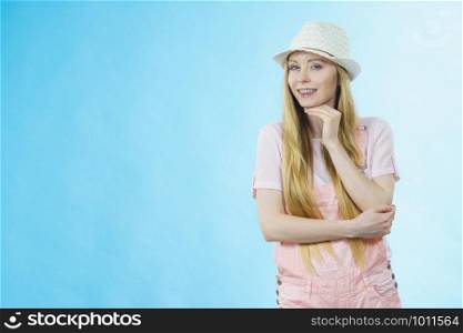 Happy cheerful teenage young woman ready for summer wearing pink outfit and sun hat.. Happy woman wearing summer outfit