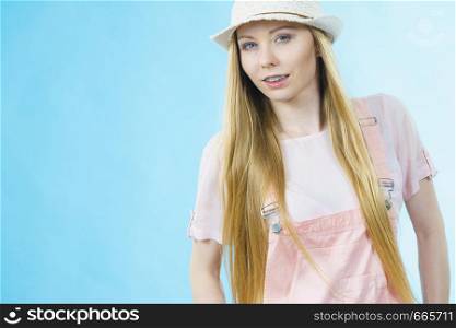 Happy cheerful teenage young woman ready for summer wearing pink outfit and sun hat.. Happy woman wearing summer outfit