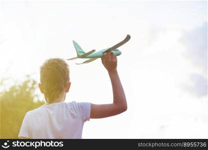Happy child boy playing with toy airplane outdoor.. Happy child boy playing with toy airplane outdoor at sunset