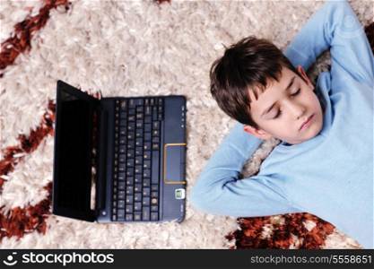 happy child boy relax at home with laptop computer in background