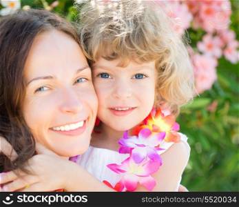 Happy child embraced your mother outdoors. Summer vacations