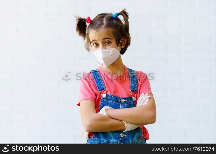 Happy Child girl wearing a protection mask against coronavirus during Covid-19 pandemic. KN95 mask.. Child girl wearing a protection mask against coronavirus during Covid-19 pandemic