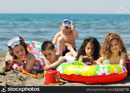 happy child group have fun on beach while playing with toys running jumping