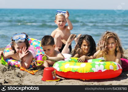 happy child group have fun on beach while playing with toys running jumping