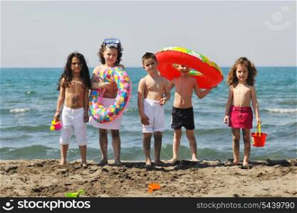 happy child group have fun on beach while playing with toys running jumping