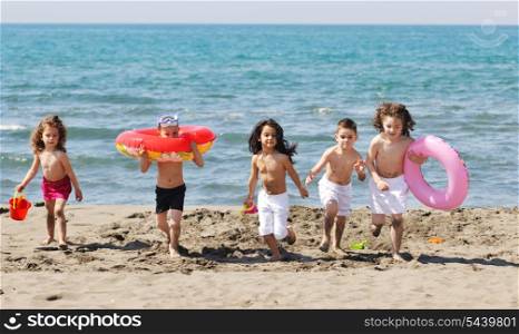 happy child group have fun on beach while playing with toys running jumping