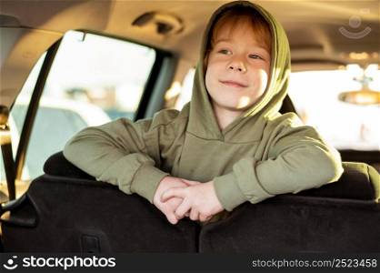 happy child inside car while road trip