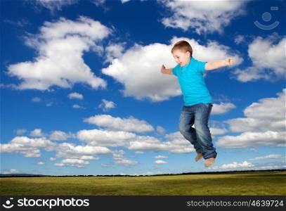 Happy child jumping on the medaw with a beautiful sky of background